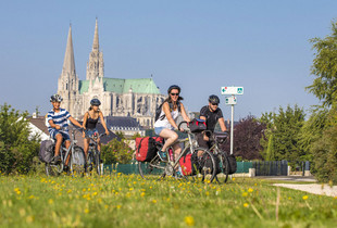 Des cyclistes sur la Véloscénie avec en fond la cathédrale
