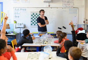 Un professeur parle à ses élèves dans une salle de classe.